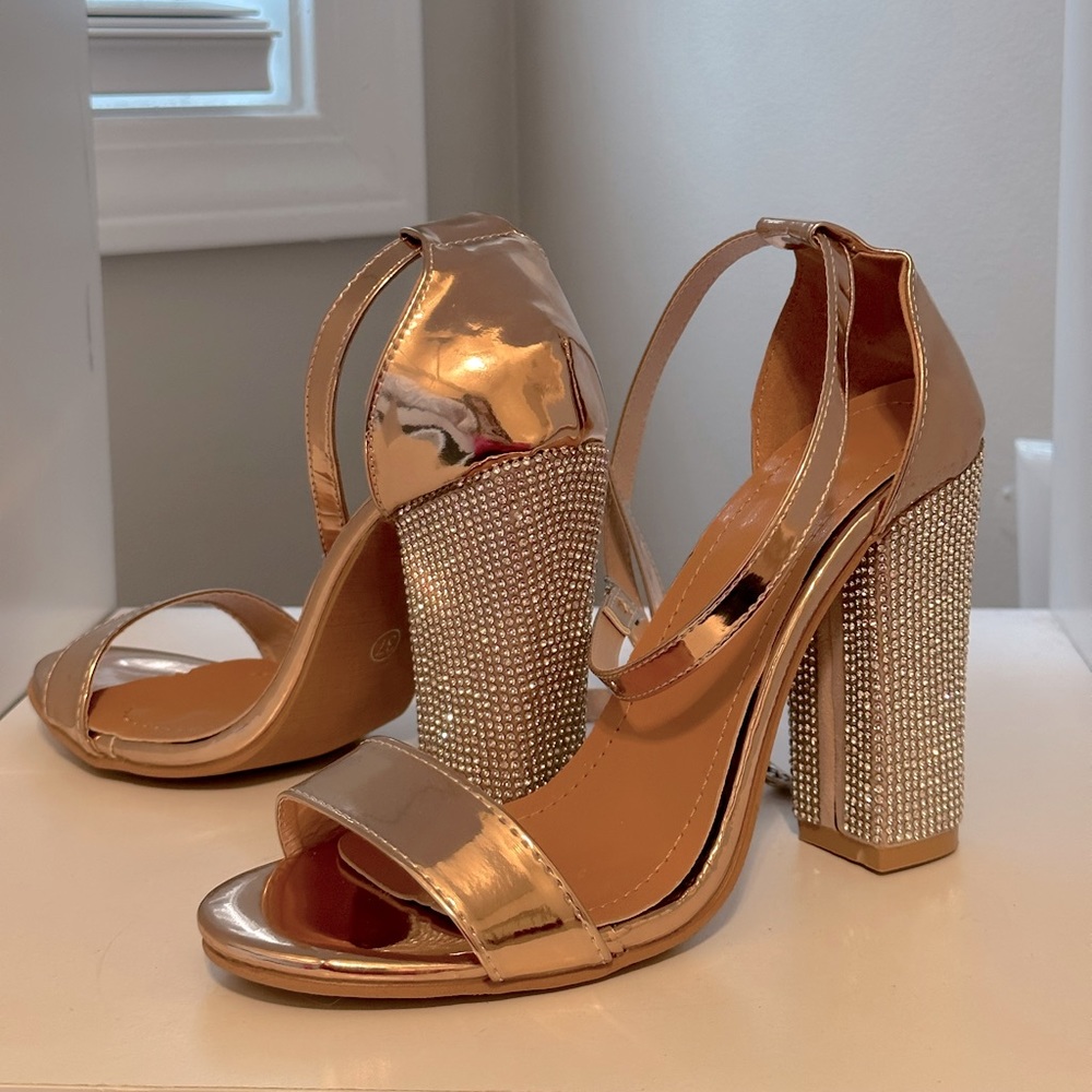 A rose gold pair of Hills straps wrap up around the leg